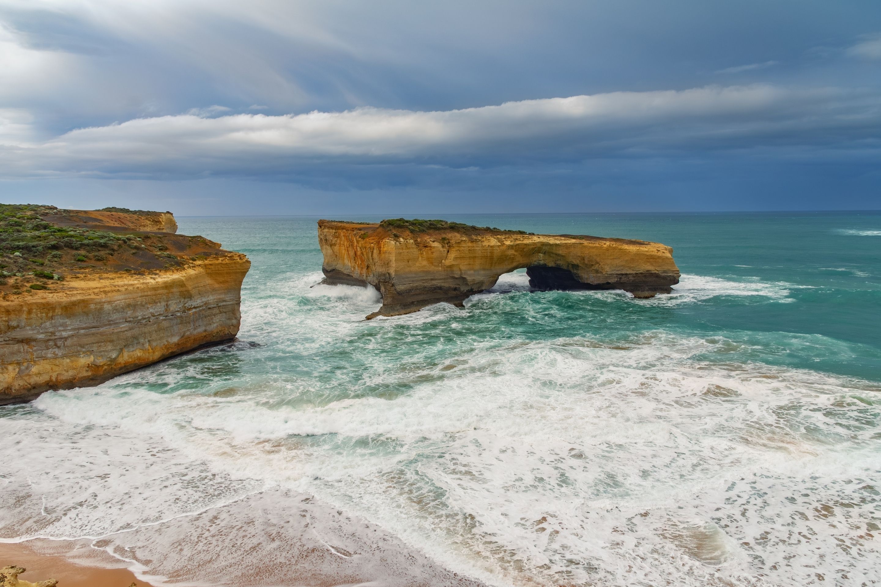 rocky outcropping in the ocean with the waves