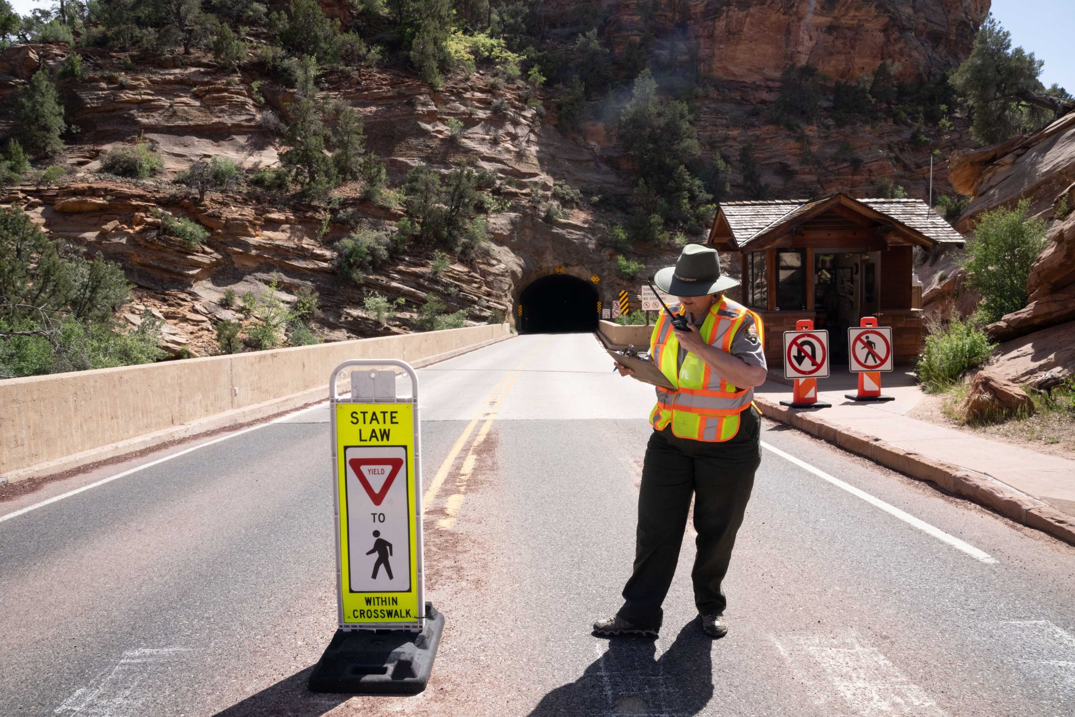 a NPS ranger stands at entrance gate