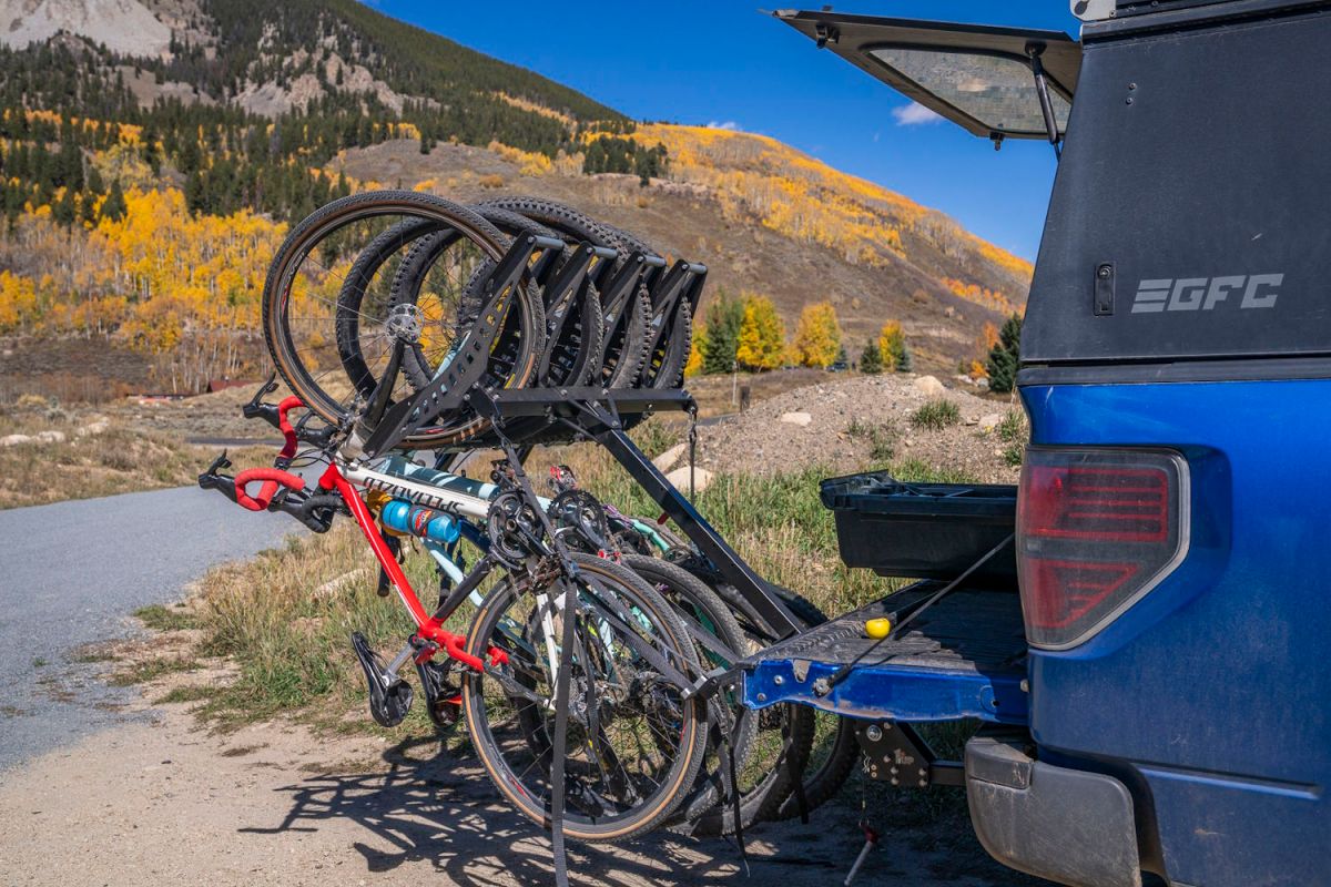 A set of bicycles secured on a rear rack of a truck