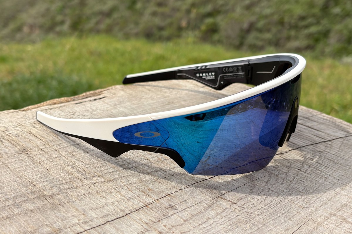 Side view of Oakley Meta AI Vanguard glasses on wood surface