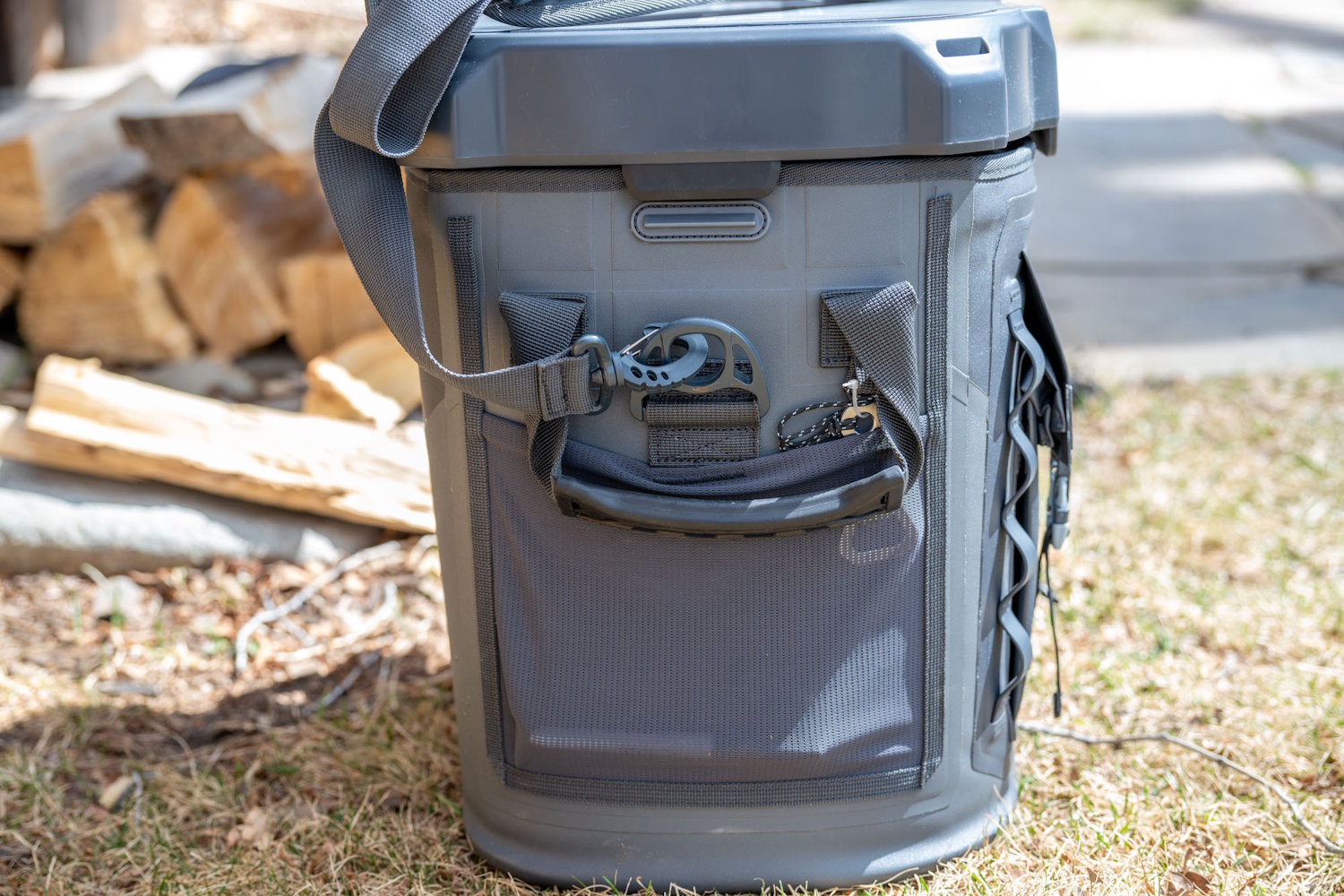 Side view of the Titan PRO cooler showing a mesh storage pocket, chain gear loops, and shoulder strap attachment.