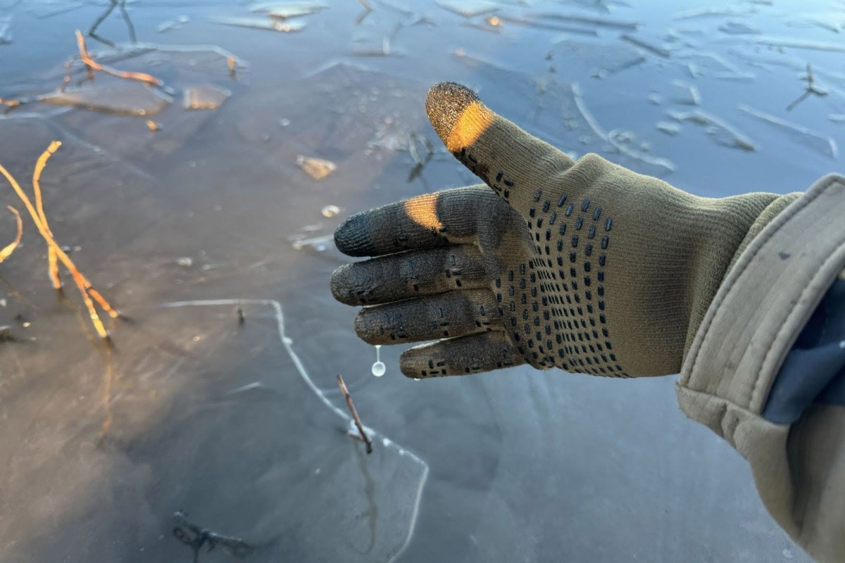 wet Cross Point Gear Pro Wool Glove above ice covered water