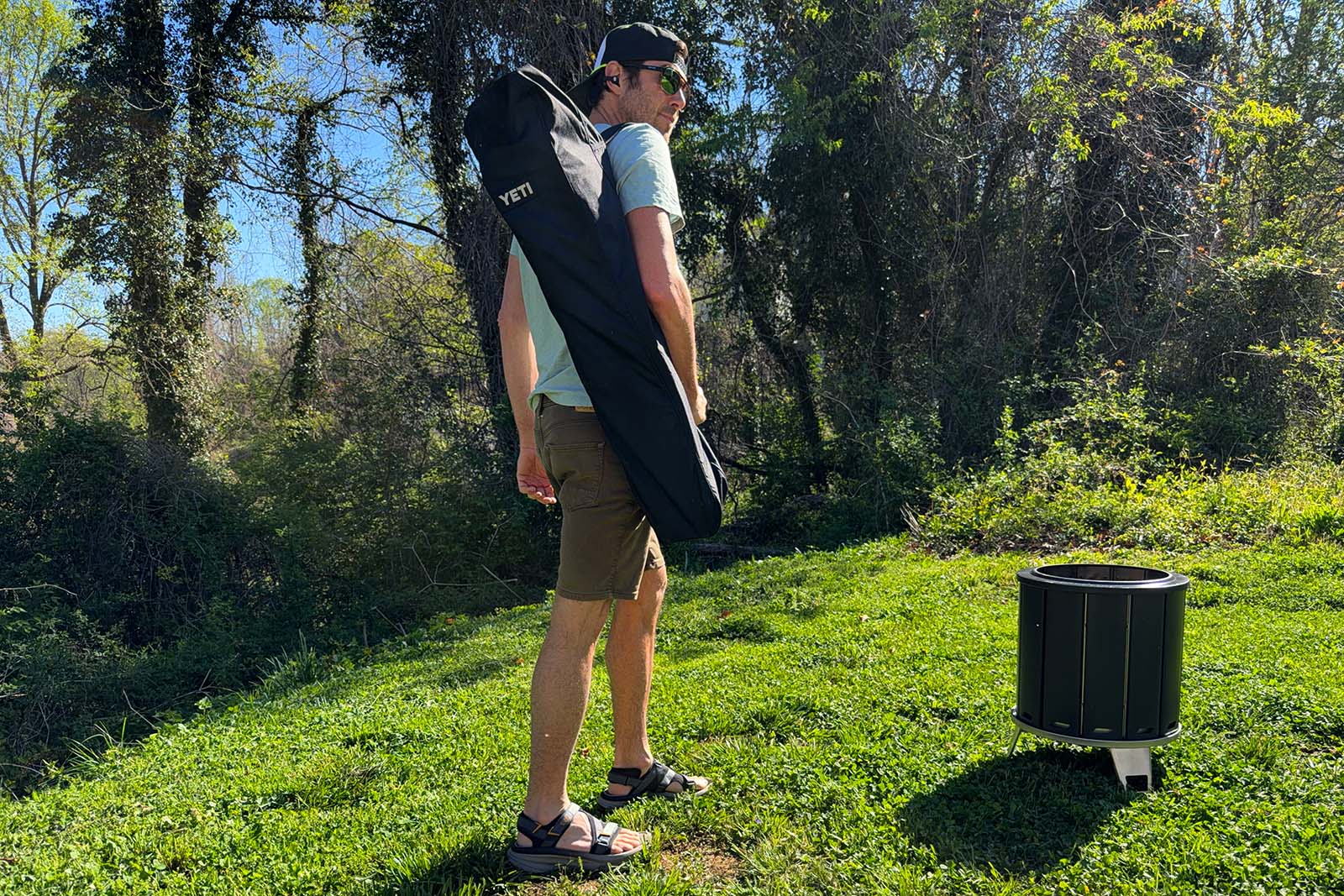 man carrying yeti trailhead field chair outside in pack
