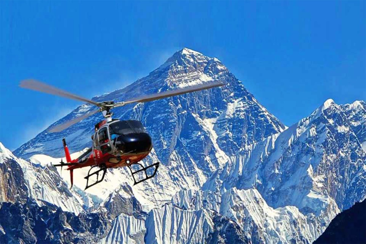 A helicopter in front of Everest