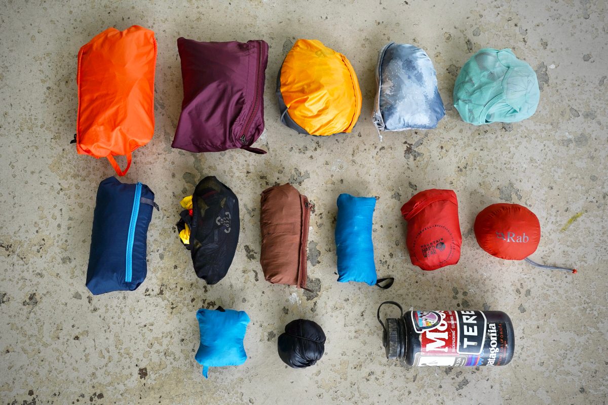Windbreaker jackets lined up next to each other in their stuff sacks