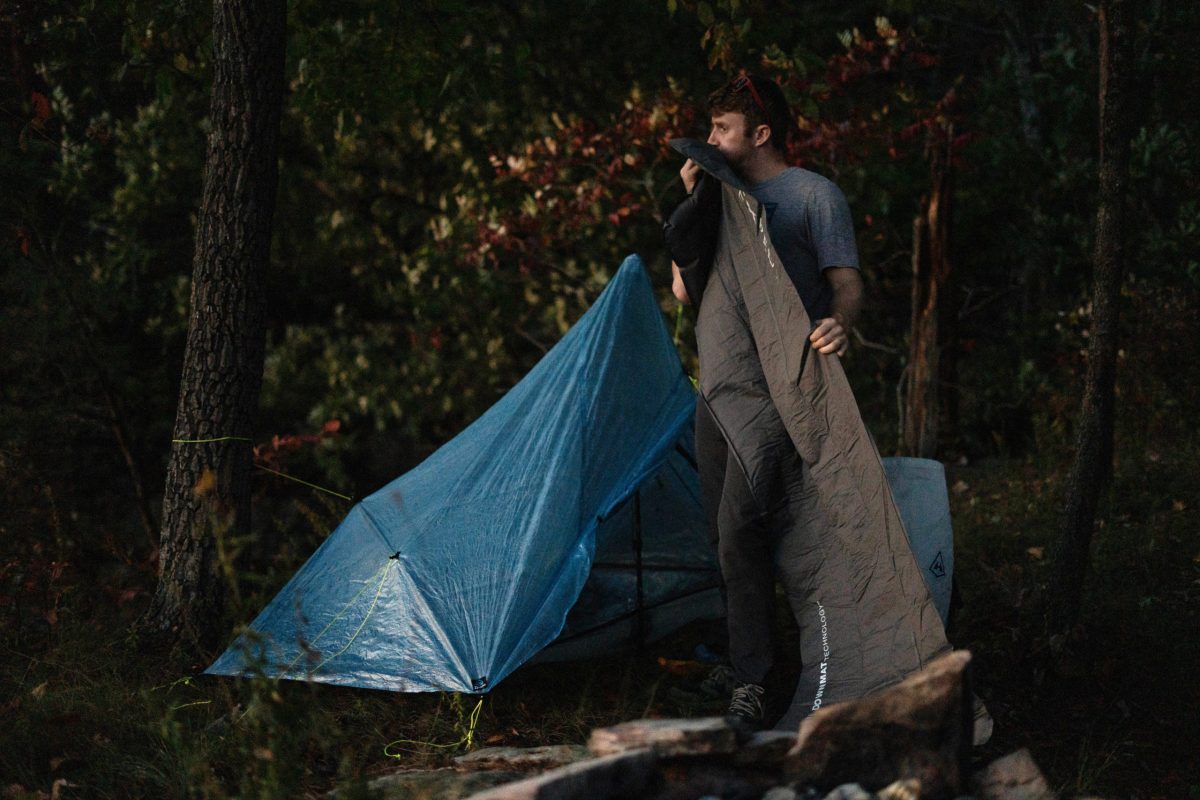 gearjunkie tester chris carter inflates a backpacking sleeping pad while camping in Tennessee 
