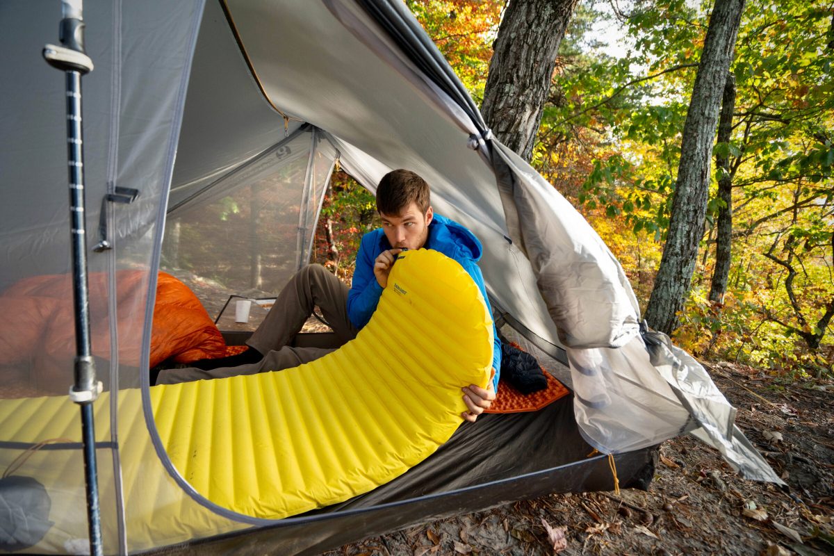 gearjunkie tester inflates the therm-a-rest xlite pad by mouth while sitting in a gossamer gear backpacking tent