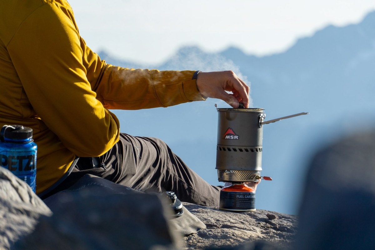 tester nick belcaster boils water in the msr reactor stove system on a climb of kulshan in the north cascades