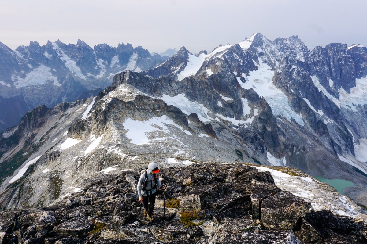 a climber ascends a snowy ridge in north cascades