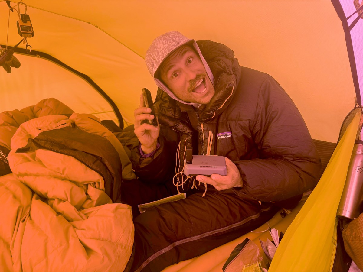 a climber talks on the Iridium GO! phone