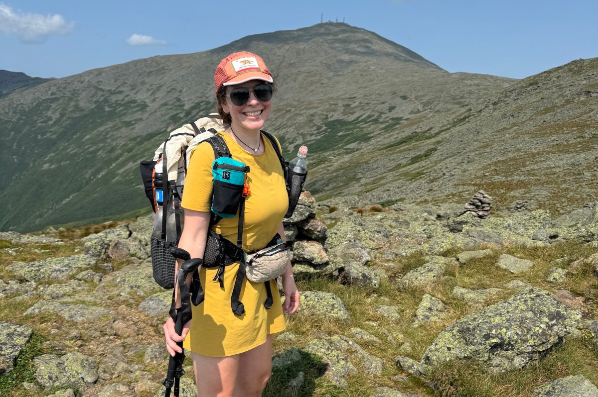 woman in yellow dress hiking to Mt. Washington, New Hampshire