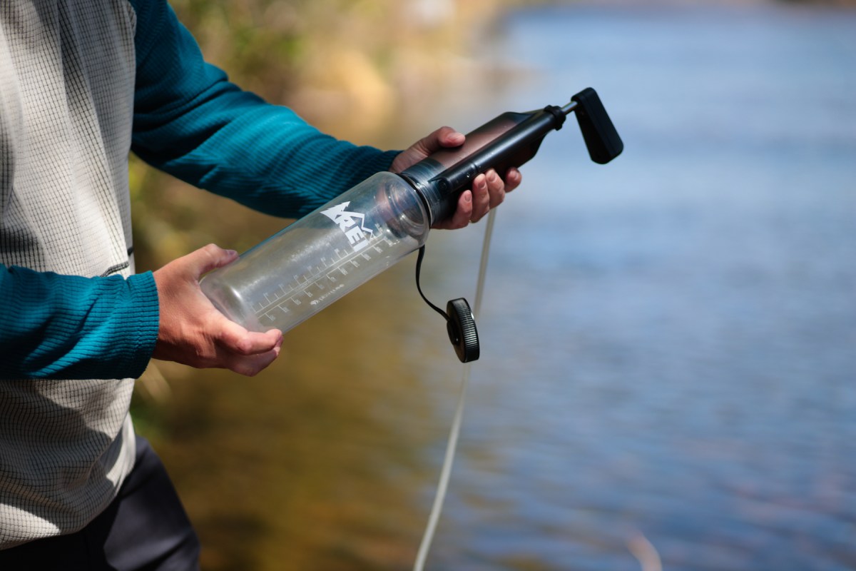 Person using the Explorer Pro with a water bottle beside a lake
