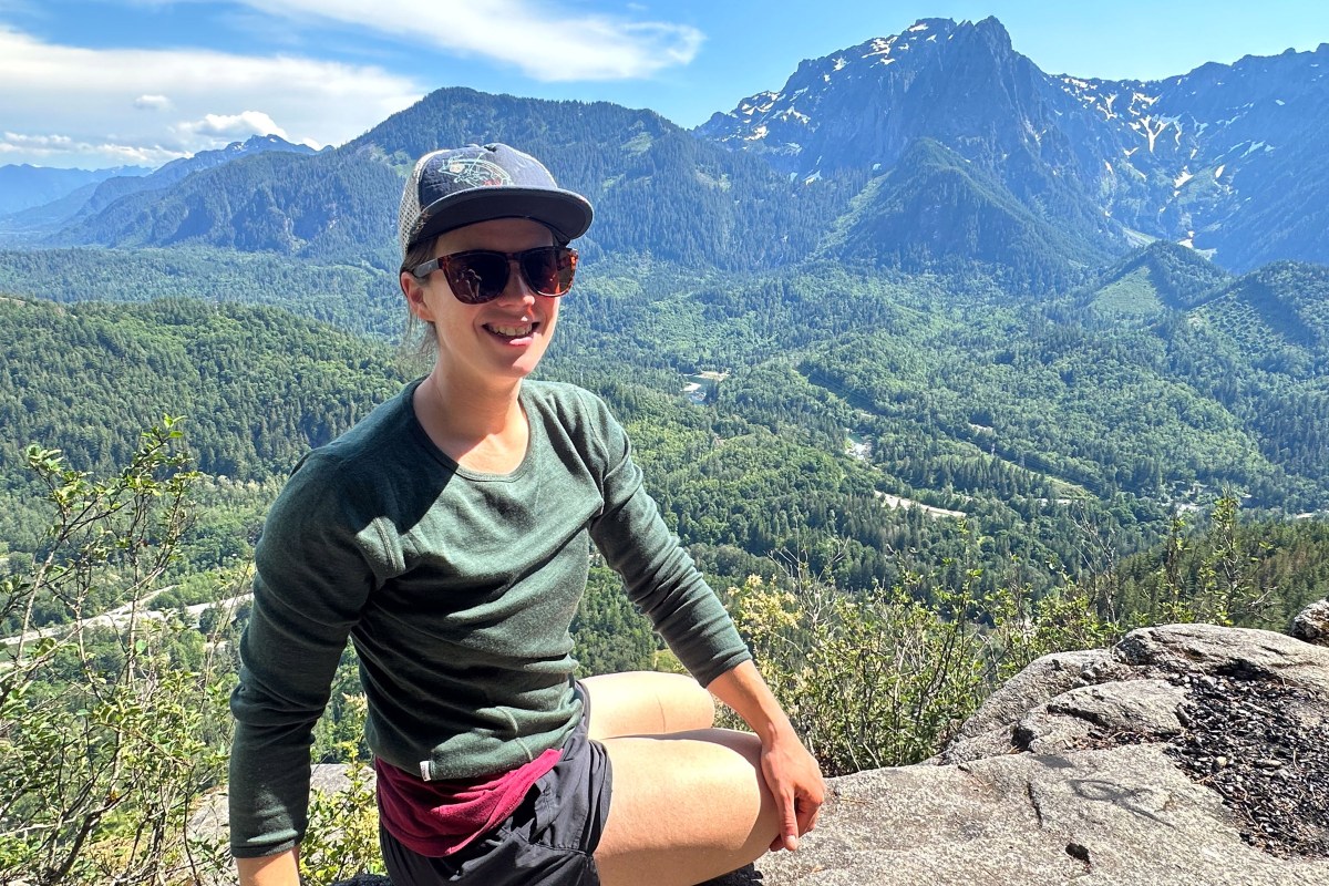 gearjunkie tester katie griffith wears a long-sleeve merino wool shirt while climbing at index in washington state