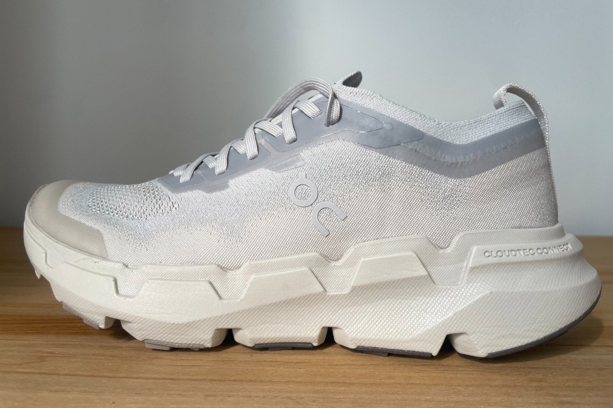On Cloudsoma shoe shown from the side with a knit upper, laces, and thick trail outsole