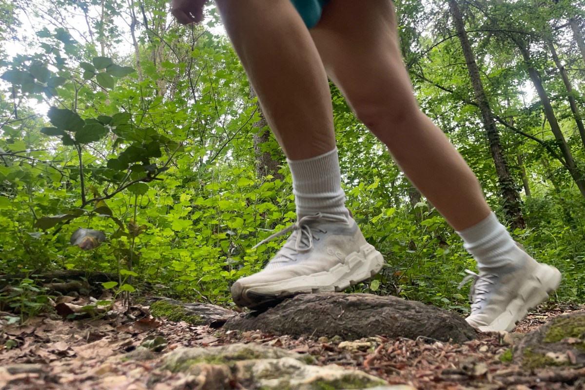 Cloudsoma shoes worn while moving over roots on a wooded trail