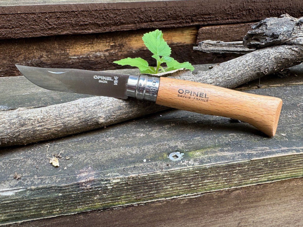 Opinel No.08 knife on stick and rock