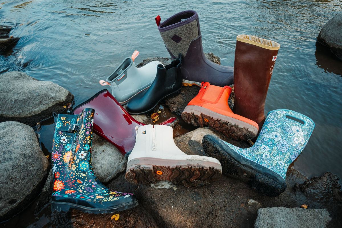 a selection of rain boots tested by gearjunkie on the shoreline 