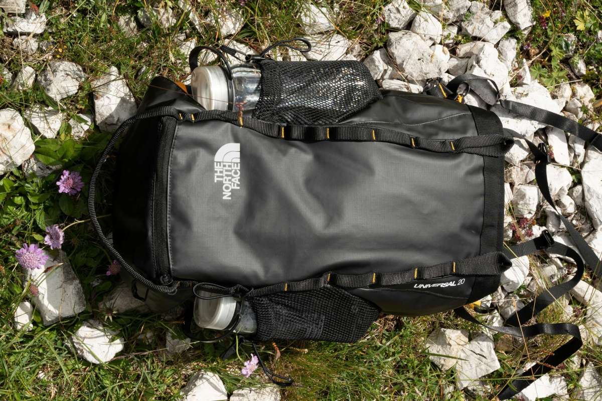 black backpack in field of lowers