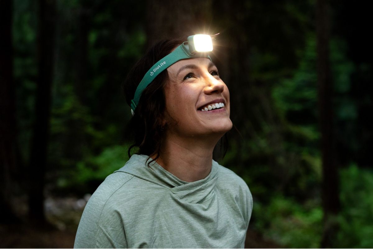 woman wearing headlamp outside that's turned on 