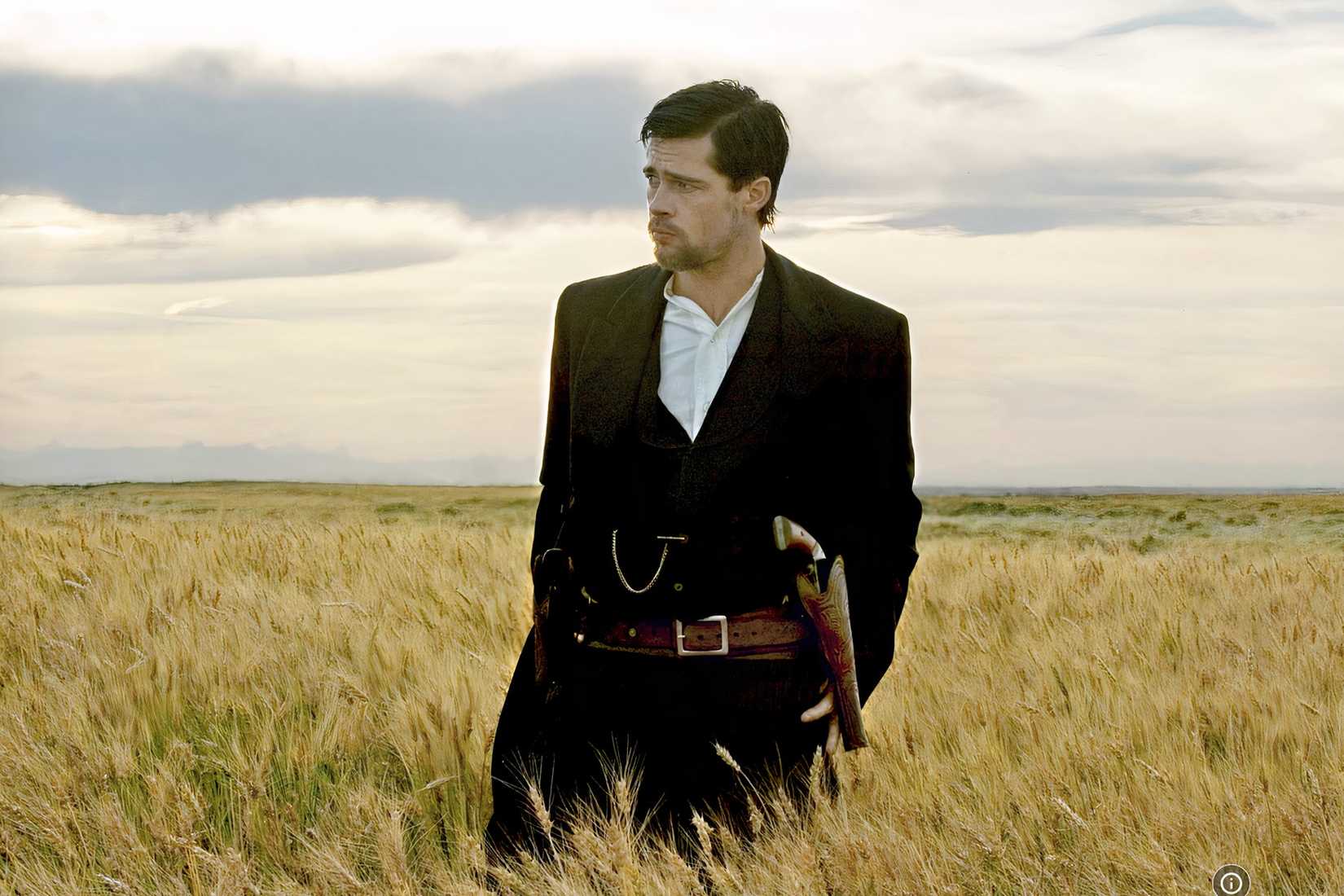 Jesse James stands in a windswept field in The Assassination of Jesse James by the Coward Robert Ford.