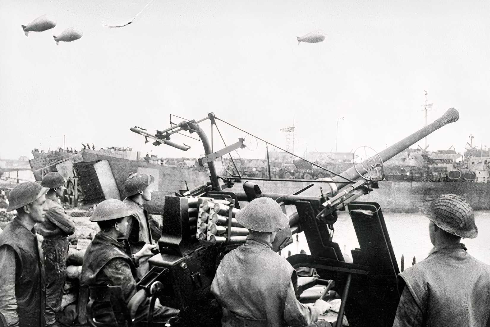 Allied service members operate an anti-aircraft gun near ships and barrage balloons during Operation Overlord.