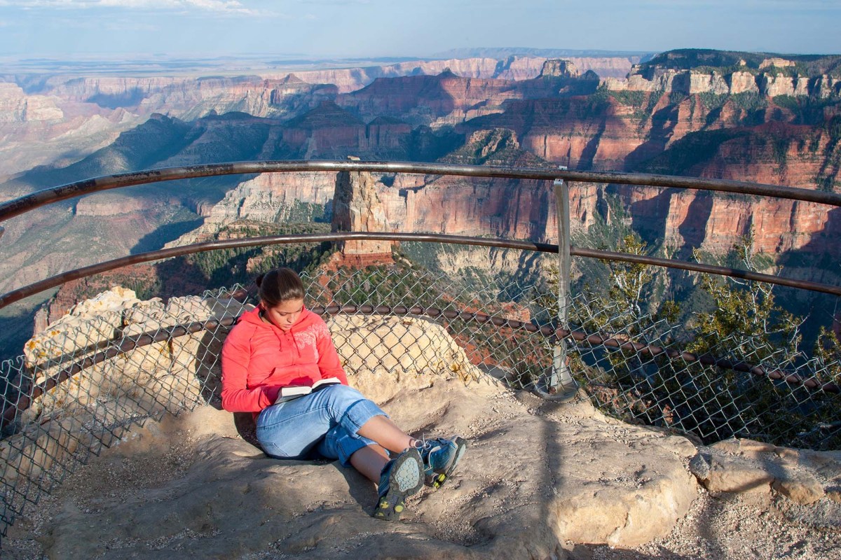 Young,Woman,Reading,Book,At,Point,Imperial,On,North,Rim