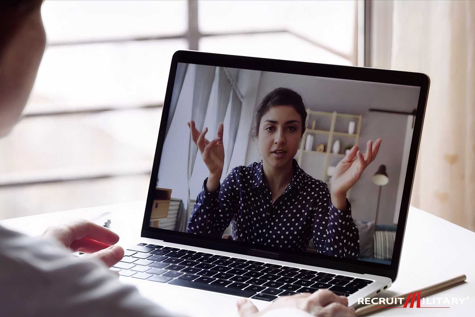 A person participates in a virtual job interview on a laptop.