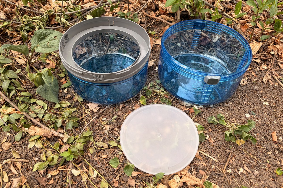 The blue BV ONE canister is shown in separated pieces, with two blue sections and a clear lid on the ground