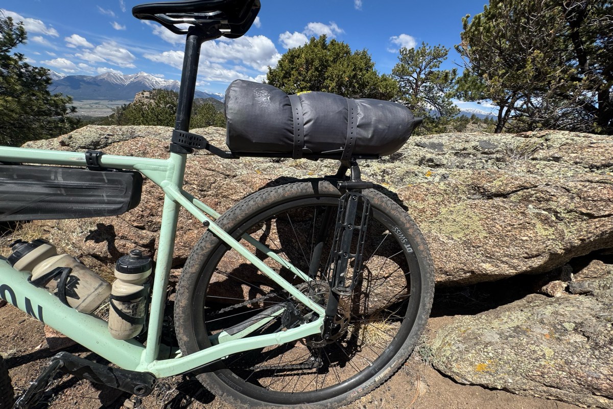 Tiger Wall UL2 Bikepack Tent packed in a gray bag and strapped to the rear rack of a bike
