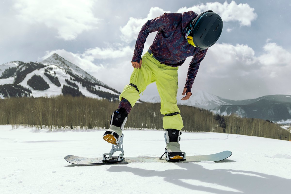 Stepping into snowboard binding with Burton boots on snow
