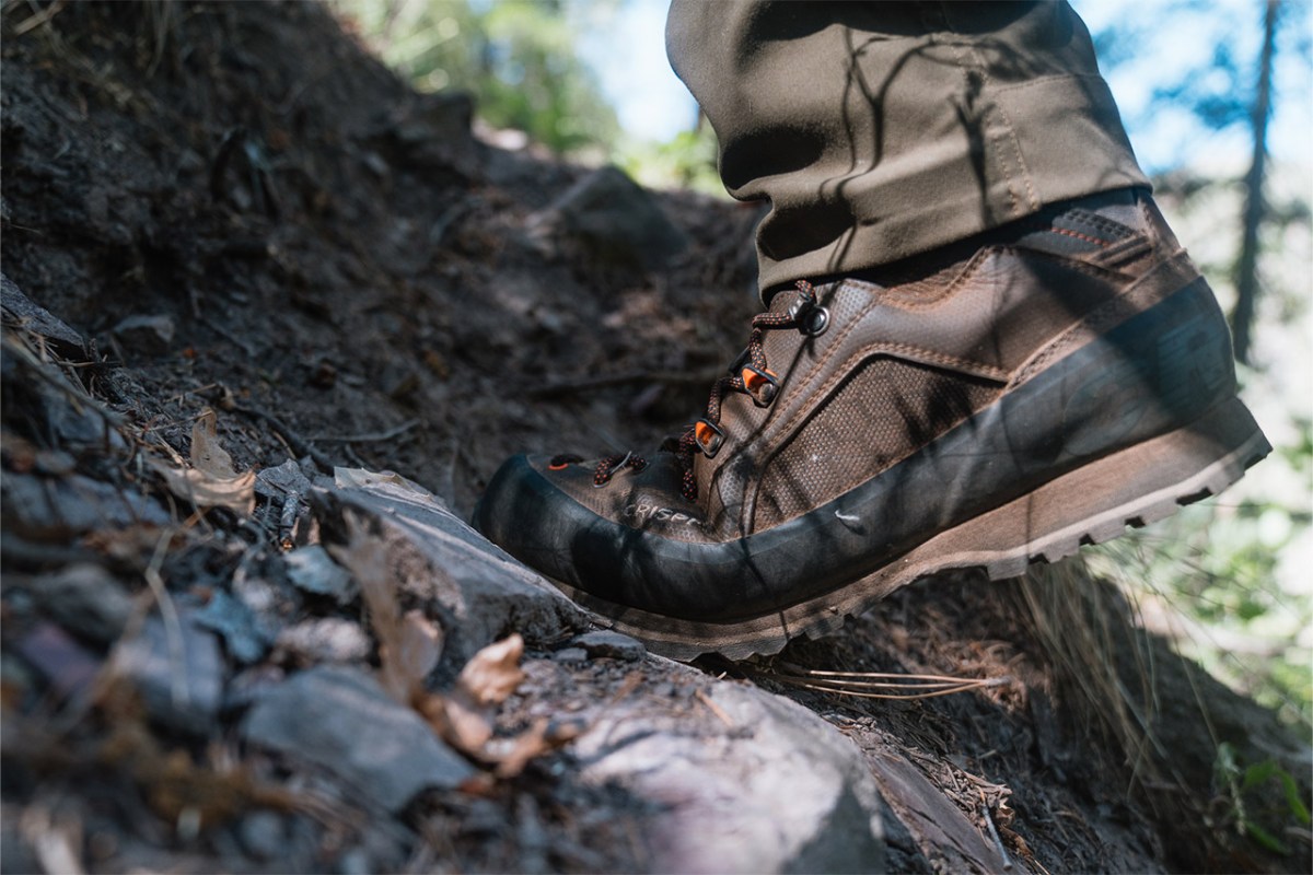 Crispi Alpine Lite boot stepping over loose rocks and dry leaves on a steep trail