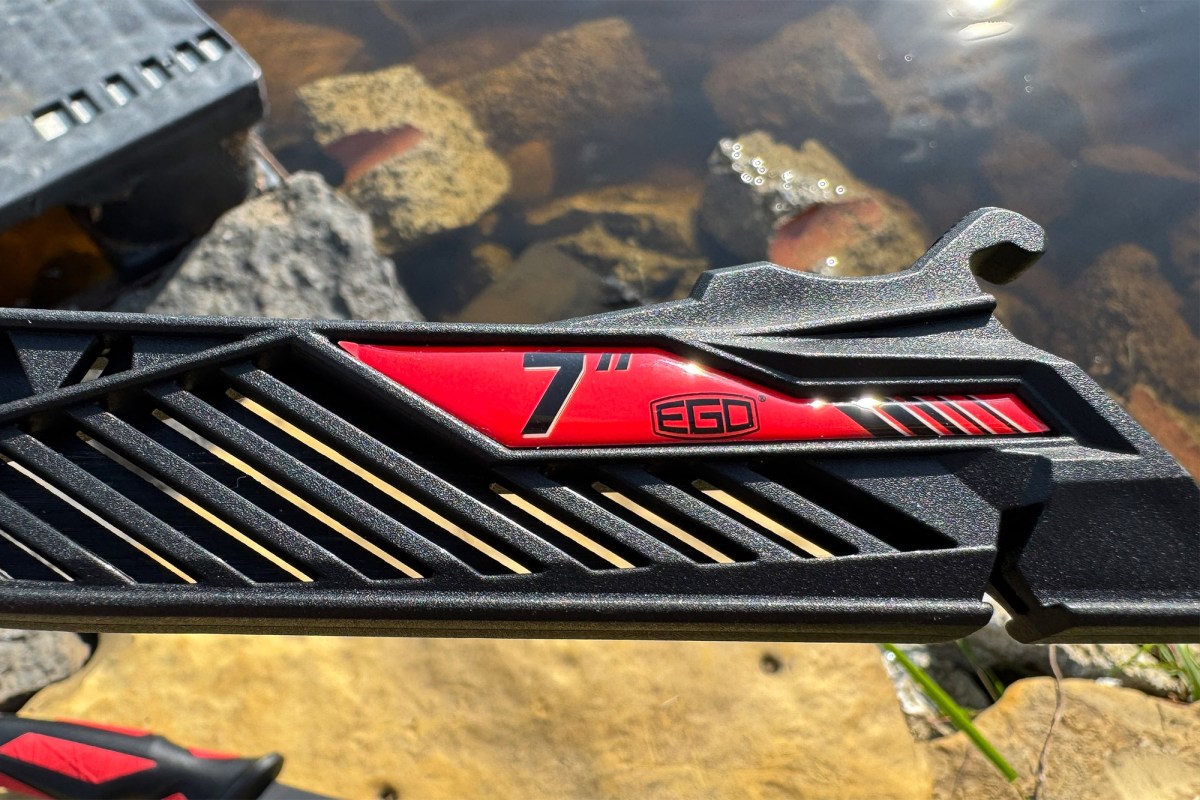 A close view shows the black sheath for the EGO 7 inch fillet knife with red EGO branding near the water