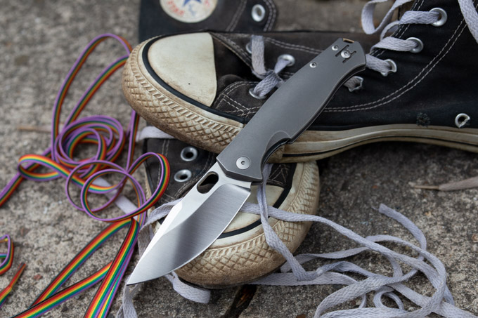 GiantMouse Pontius knife displayed on black sneakers with loose laces