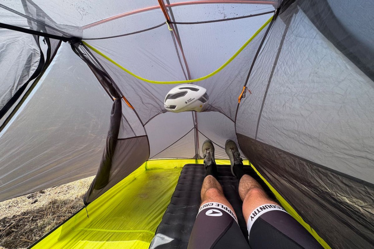 Bike helmet hanging inside the Tiger Wall UL2 with a sleeping pad on the floor