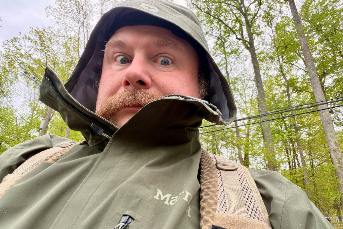 Person wearing the Marmot PreCip Evo Pro jacket with the hood up in the rain