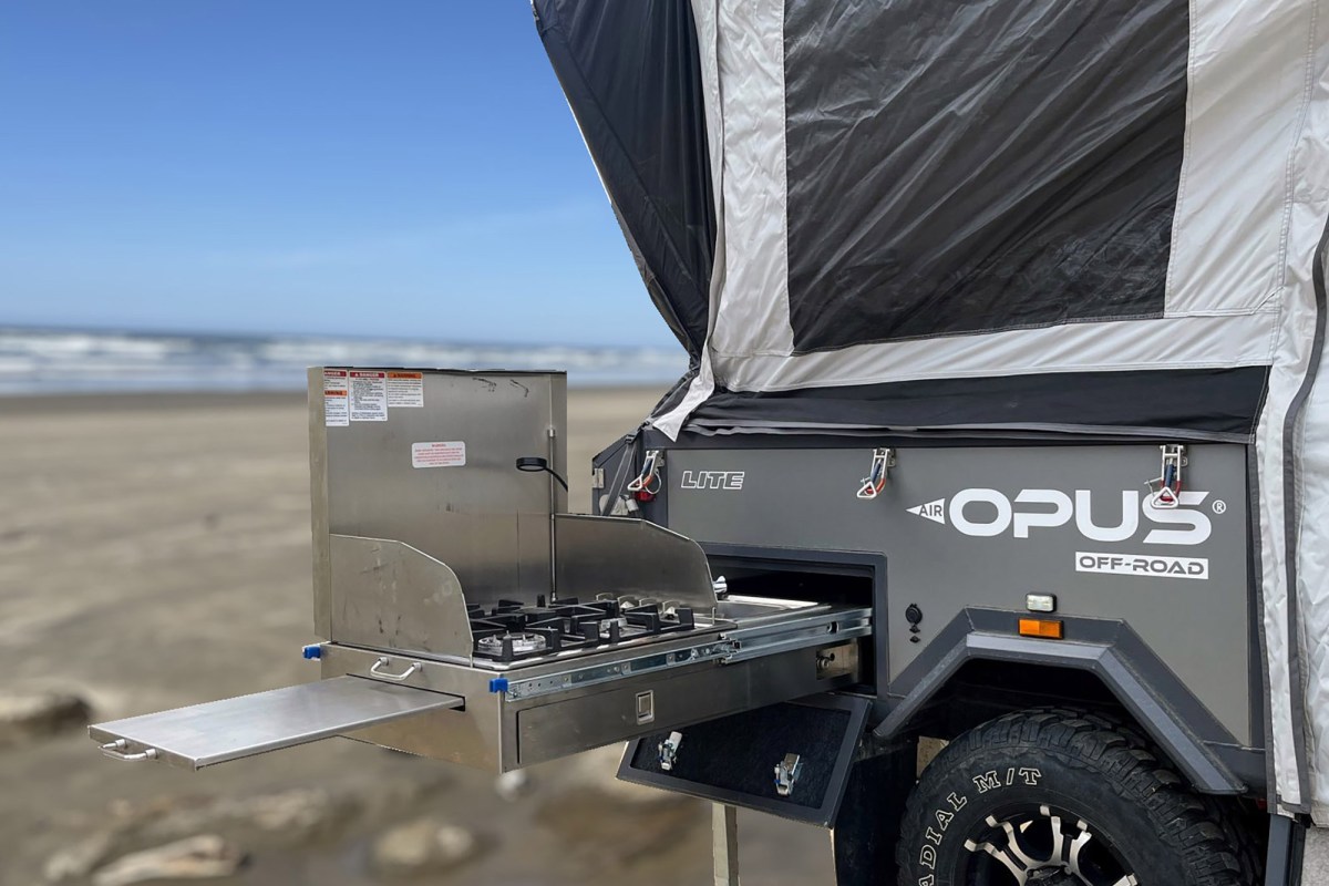 OPUS OP Lite slide-out galley with a stove beside the beach