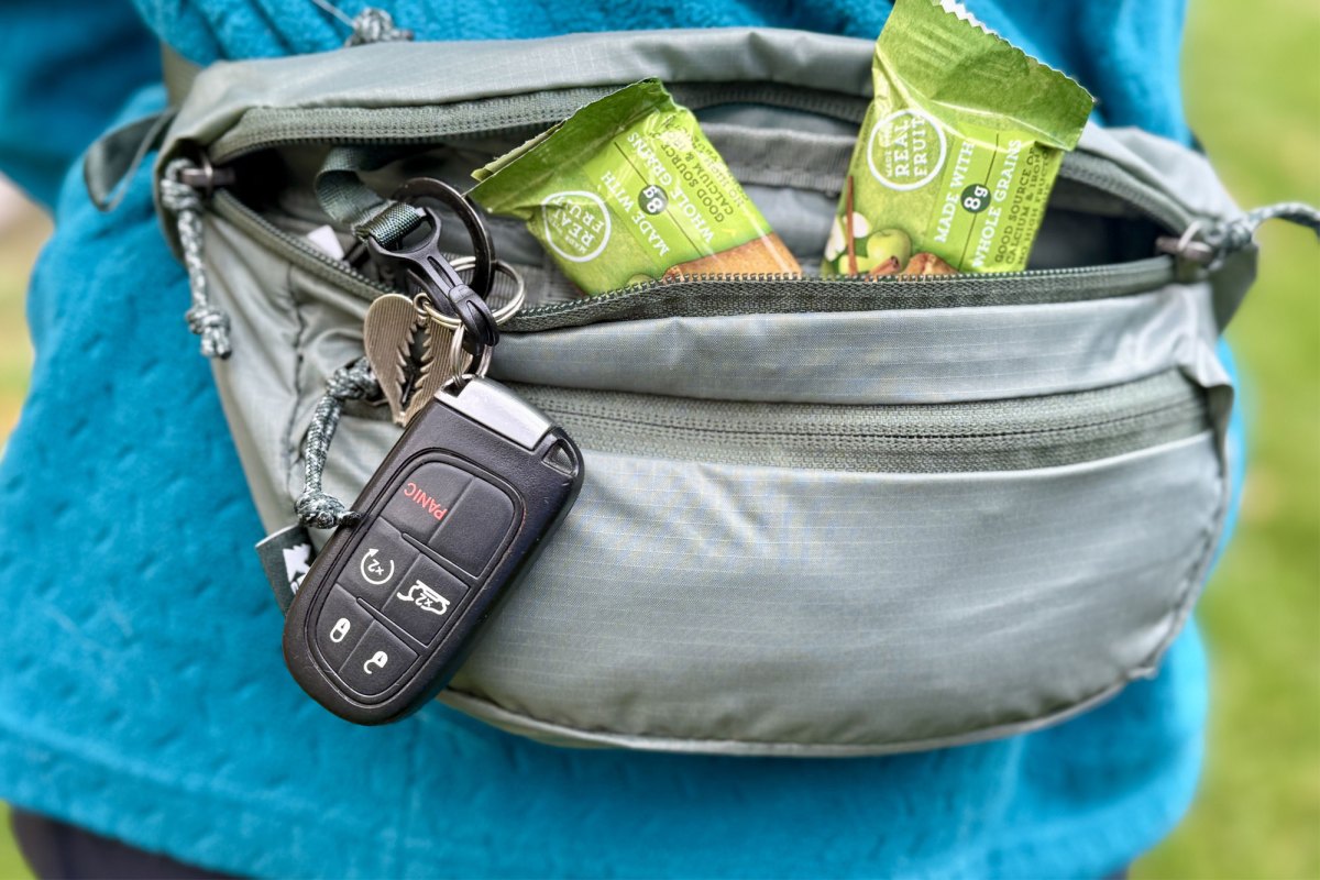 a person with essential in the REI Co op Trail 2 Waist Pack
