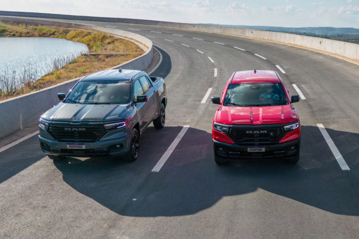 Two Ram Rampage pickups driving side by side on a curved road