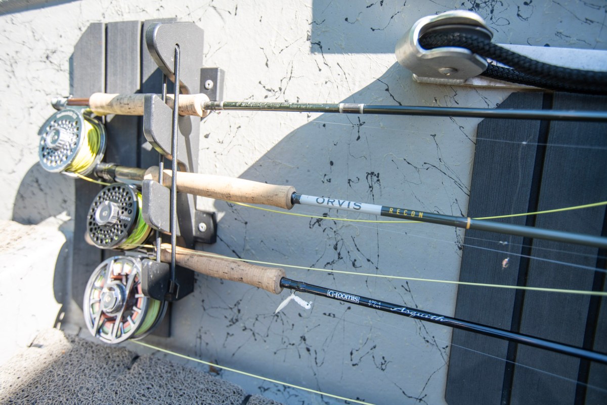 Three fly rods in a rod holder on a driftboat.