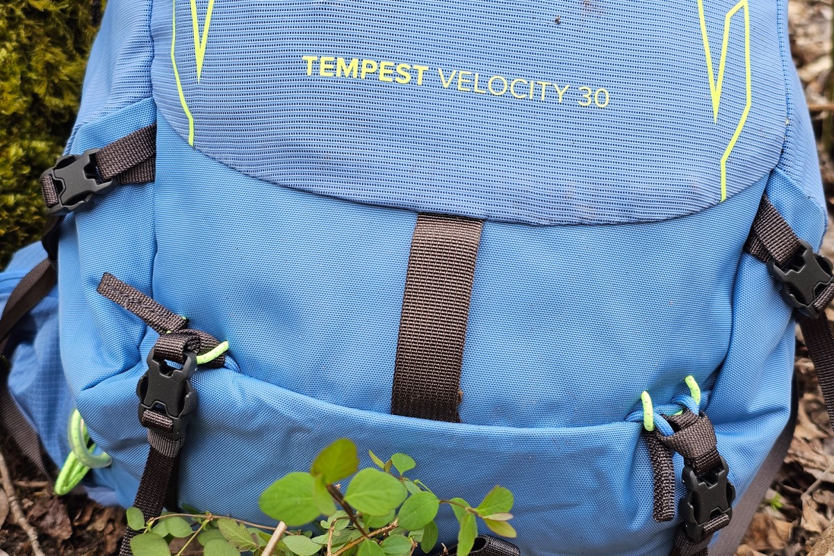 Close up of the front panel and logo on a blue Osprey Tempest Velocity 30 pack
