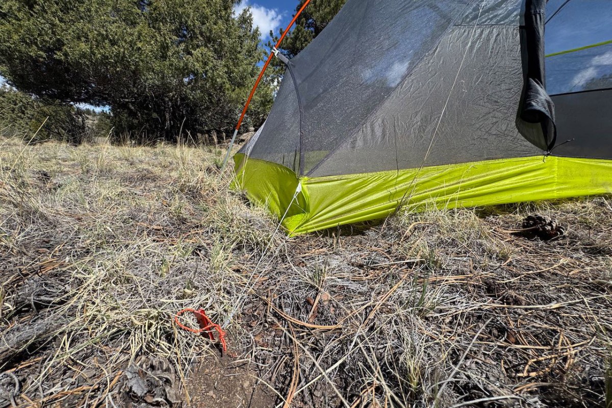 Close view of the Tiger Wall UL2 tent body staked into dry grass and dirt