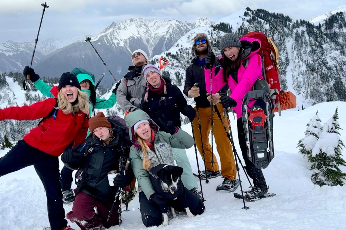 group of skiers smile on mountain