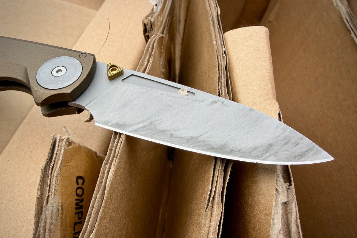 Work Sharp RMX Thumbstud blade with cardboard residue after cutting