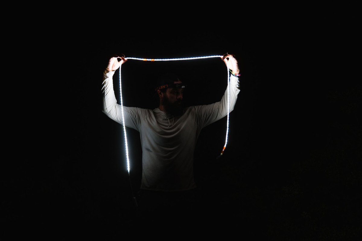 a man holding a light rope