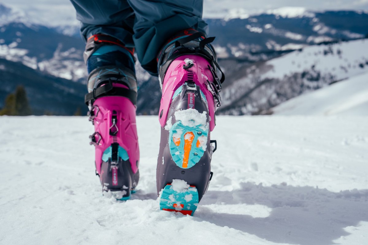 Rear view of skier walking in snow wearing Rossignol AllTrack 130 Elite LV LT Ski Boots