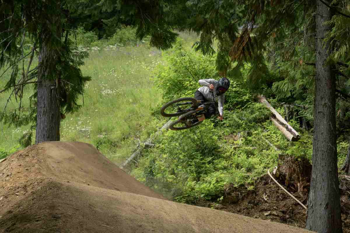 GL Manager Dane Tudor testing the 30-foot shark fin, an angled jump coming out of a corner, on upper Obsidius at RED Bike Park; photo/Ashley Voykin