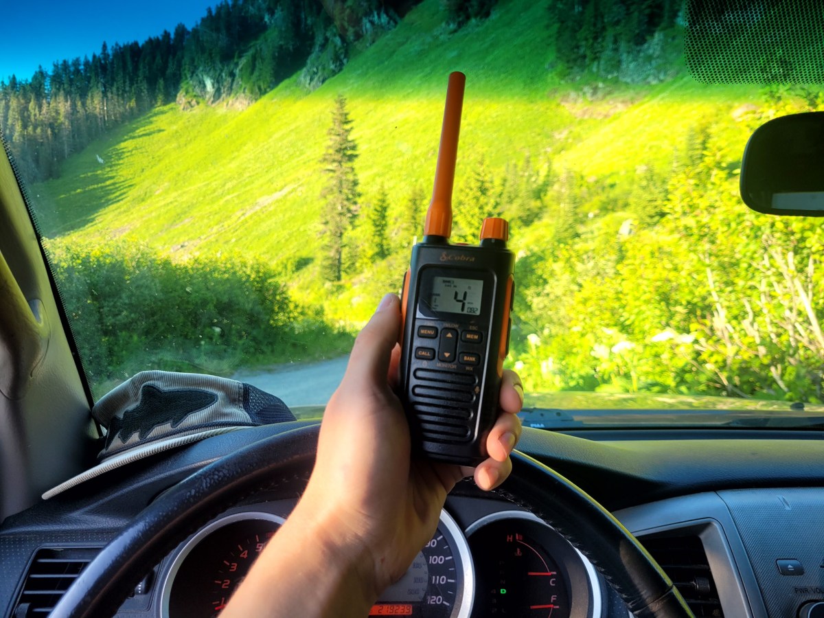 the author holds the cobra trailblazer 450 gmrs radio while offroading in washington state