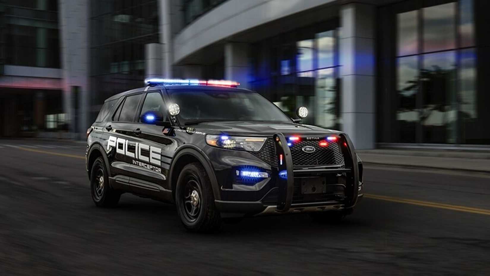 Ford Police Interceptor Utility on the road with lights on