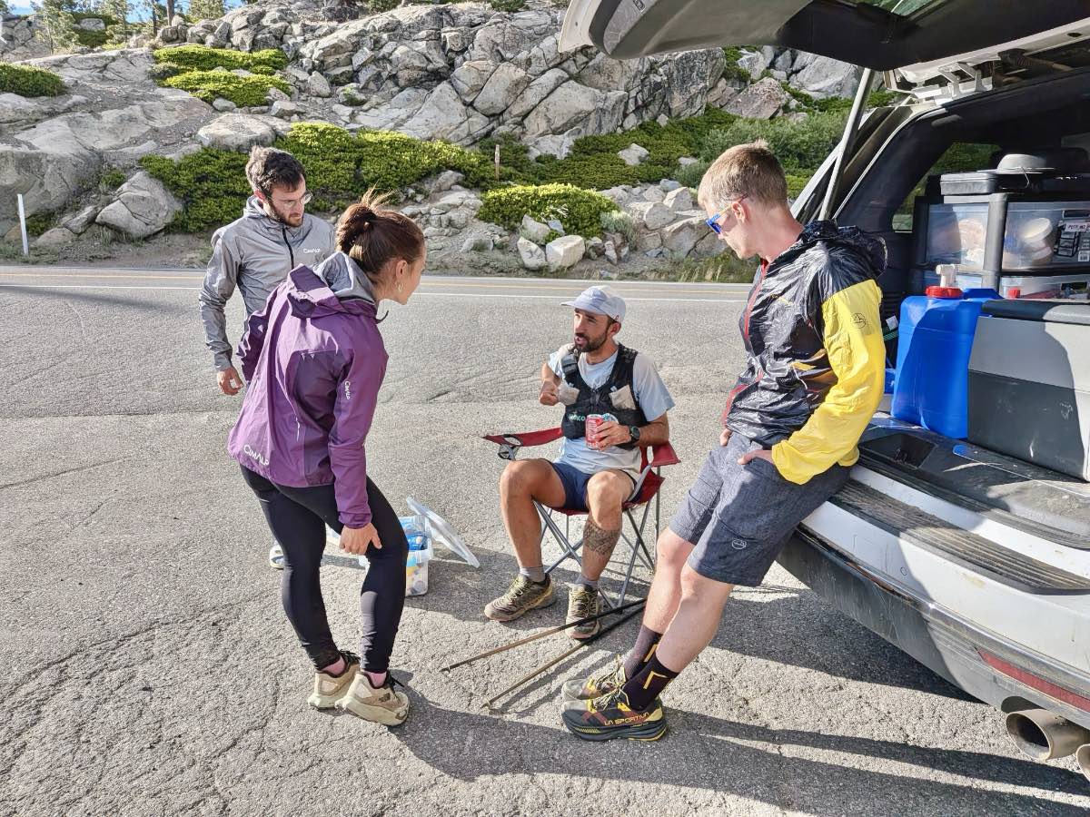 group sitting my open truck of van