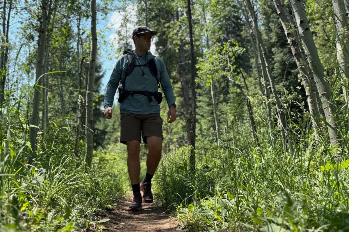 Hiker testing the Exped Lightning 50 backpack on a forest trail